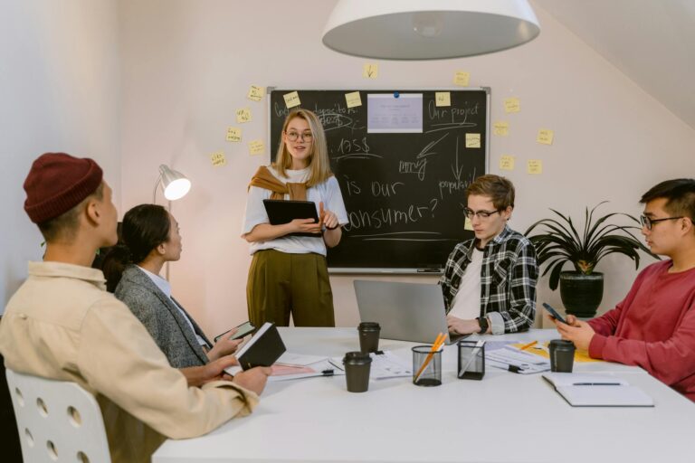 A diverse group of professionals engaged in a collaborative meeting in an office environment.