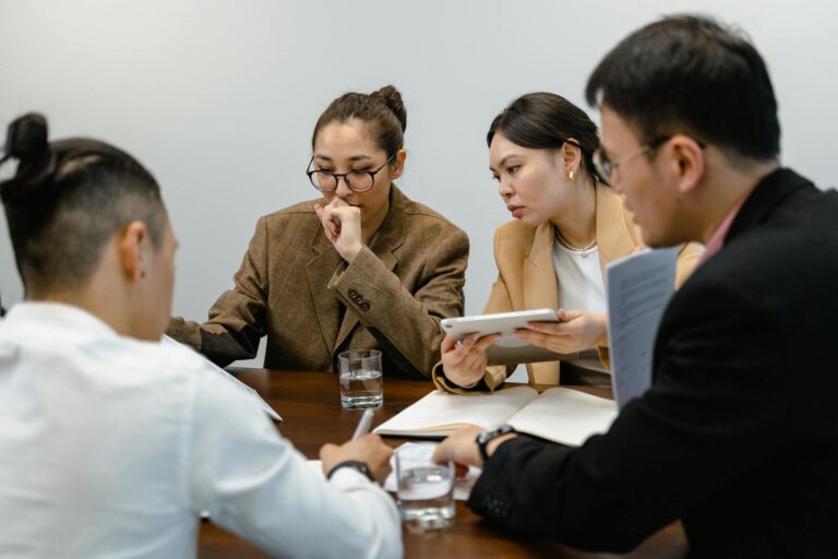 Professional team engaged in a brainstorming session in a modern office setting.
